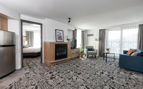 a living room with a couch and a fireplace at The Crystal Lodge in Whistler
