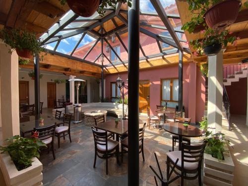 a patio with tables and chairs in a building at Hotel Villa Murano in San Cristóbal de Las Casas