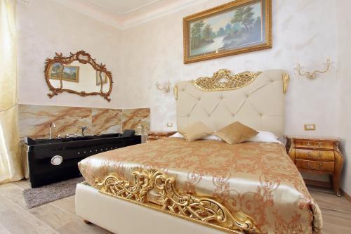 a bedroom with a gold bed and a sink at Just Chilling Suite in Rome