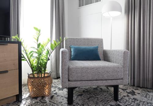 a chair with a blue pillow in a living room at The Crystal Lodge in Whistler