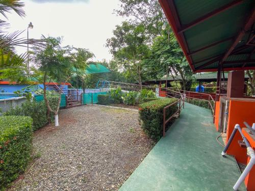 a water park with a slide and a playground at Hotel Cabinas el Tecal in Uvita