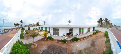 a white house on the beach with the ocean at Sunshine Boutique Hotel in San Andrés