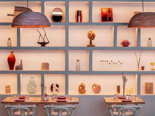 a wall filled with lots of vases and lamps at Novotel Paris Porte Versailles in Paris