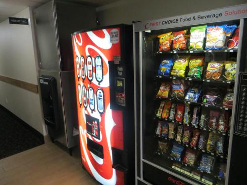 a soda vending machine in a store with snacks at Baymont by Wyndham Glenwood in Glenwood
