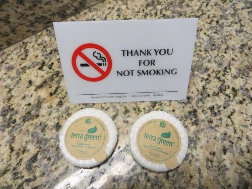 two signs sitting on top of a counter with a no smoking sign at Baymont by Wyndham Glenwood in Glenwood