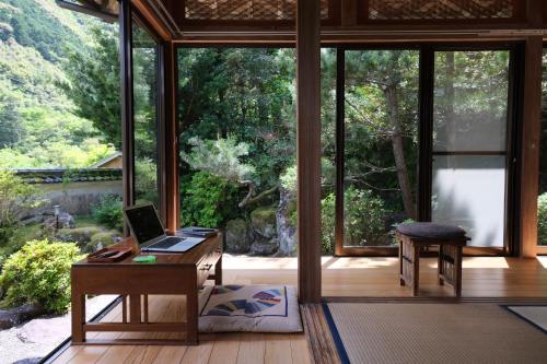 an office with a desk with a laptop on it at Shimanto Riverside Hideaway in Shimanto