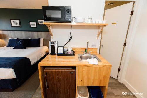 a hotel room with a sink and a bed at Surftides Hotel in Lincoln City