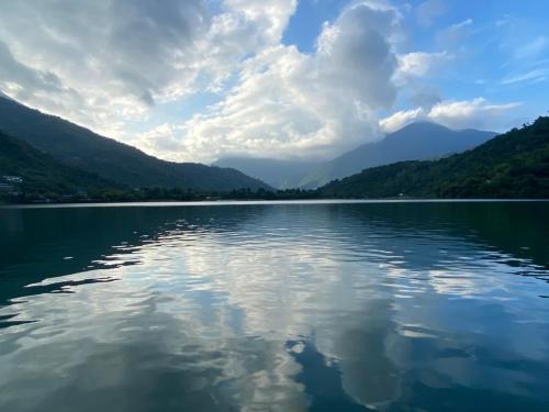 a large body of water with mountains in the background at Lakeside 46 in Chinan