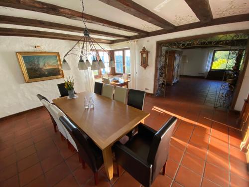 a dining room with a wooden table and chairs at Schwarzwald-Villa mit Indoor-Pool in Feldberg