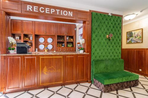 a green bar in a restaurant with a green seat at Petros Hotel in Bukovel