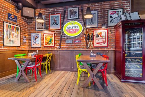 a restaurant with two tables and colorful chairs at Petros Hotel in Bukovel
