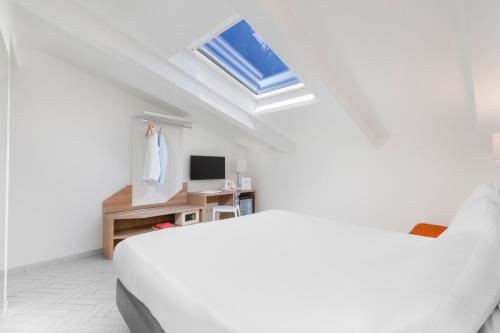 a white room with a bed and a desk at Palazzo Tasso in Sorrento