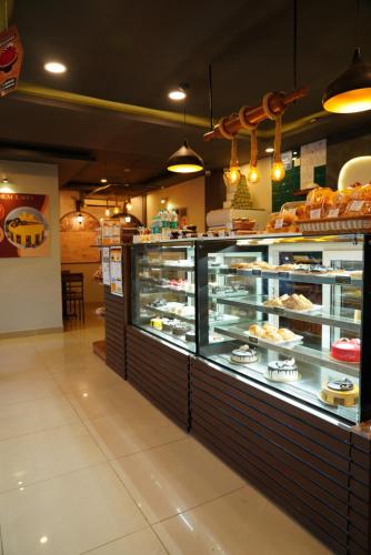 a bakery with a display case filled with pastries at Suraksha Stay ITPL Hotel Banglore in Bengaluru