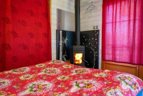a bedroom with a bed and a fire place at chalet 2 personnes in Mialanes