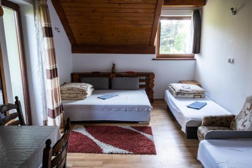 a living room with two beds and a couch at Zajazd Tadeo in Pietrzykowice