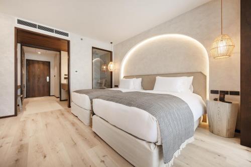 a large white bedroom with a large white bed at VALA Hua Hin - Nu Chapter Hotels in Cha Am