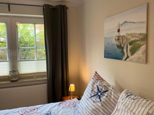 a bedroom with a bed and a window at Haus Jenny Wohnung E1 mit Terrasse in Boltenhagen