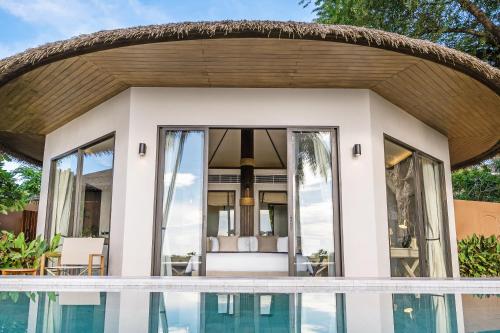 a house with a pool in front of it at VALA Hua Hin - Nu Chapter Hotels in Cha Am