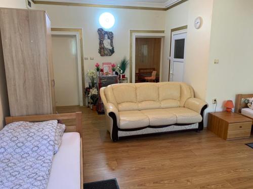 a living room with a couch and a chair at Apartman Pejica in Čačak