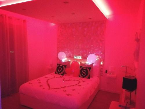 a pink bedroom with a bed with a heart drawn on it at Diamond Suite Verona in Verona