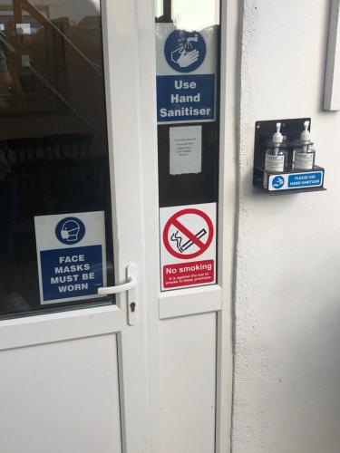 a door with signs on it with a sign on it at parklane guest house in Cardiff