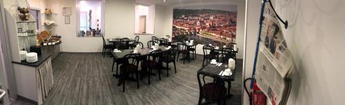 a room with tables and chairs in a restaurant at Hotel Regina in Würzburg