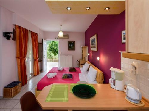 a bedroom with a large bed with purple walls at Ktima Anastasia Green Stay Nafplio in Nafplio