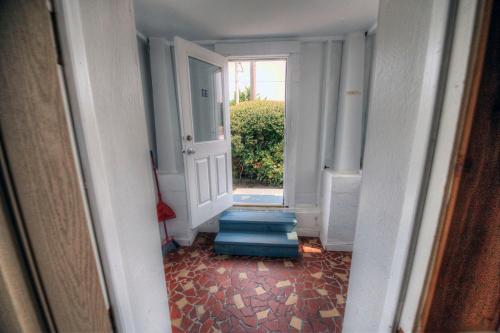 a hallway with stairs leading to a door at Outer Banks Motel - Village Accommodations in Buxton