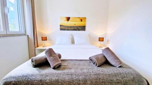 a bedroom with a bed with two pillows on it at Apartment PASMAN - appartement 50 m2 et piscine in Pakoštane