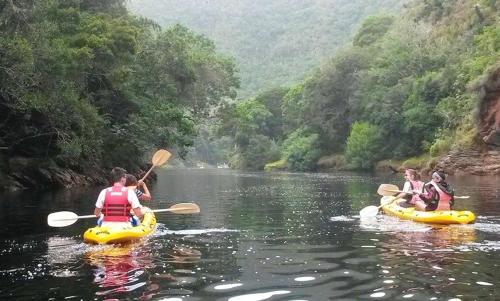 a group of people riding on kayaks on a river at Nature on your doorstep in Hoekwil