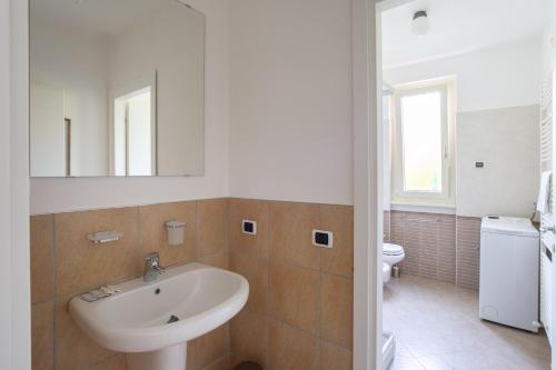 a bathroom with a sink and a toilet at Como Lake Nest - Studio with garden in Tremezzo
