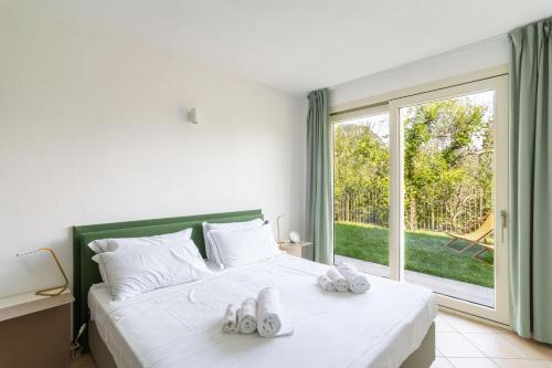 a bedroom with a bed with white shoes on it at Como Lake Nest - Studio with garden in Tremezzo