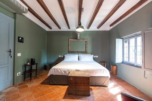 a bedroom with a bed in a room with green walls at La Locanda di Grazzano Visconti in Grazzano Visconti