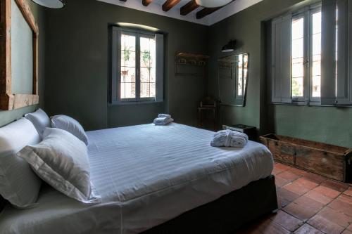 a bedroom with a large bed with two towels on it at La Locanda di Grazzano Visconti in Grazzano Visconti