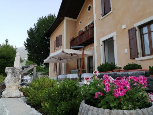 a house with flowers in front of it at La Villa degli Orti in Borgo