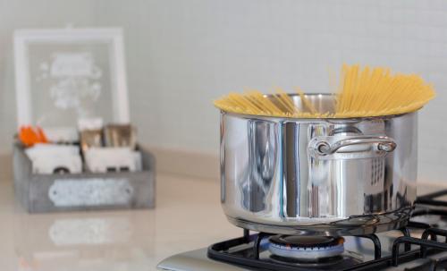 a pot on a stove with pasta in it at Nero D'Avorio Aparthotel & SPA in Rimini