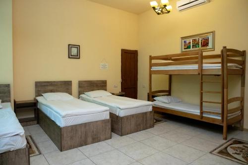 a room with three bunk beds in it at Primavera Guest House in Yerevan