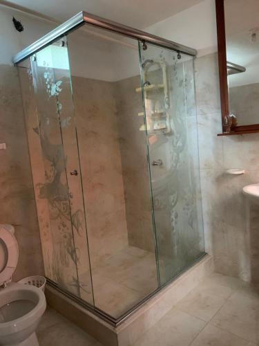 a glass shower in a bathroom with a toilet at Finca campestre en Mesitas del Colegio in La María