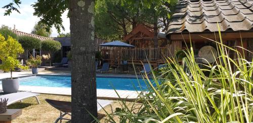 a house with a swimming pool in a yard at Le Clos des Romarins in Saint-Palais-sur-Mer