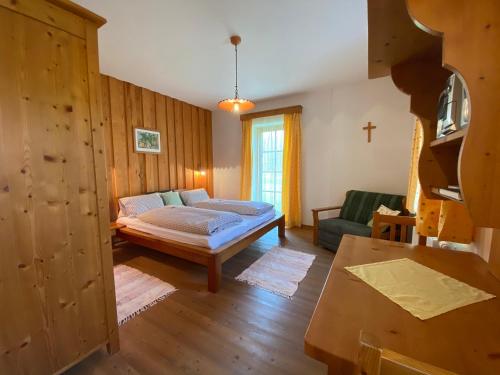 a bedroom with a bed and a cross on the wall at Kürbishof Gartner in Fehring
