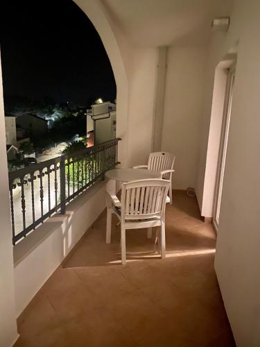 a balcony with two chairs and a table on it at Apartments Grozdana in Gradac