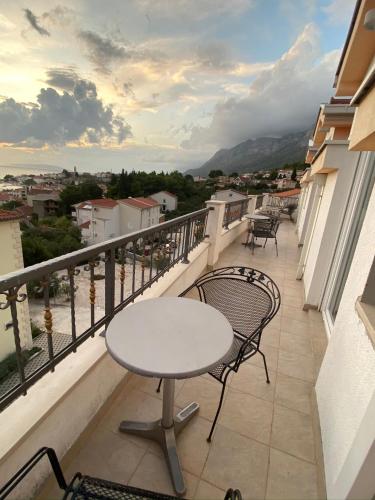 a table and chairs on a balcony with a view at Apartments Grozdana in Gradac