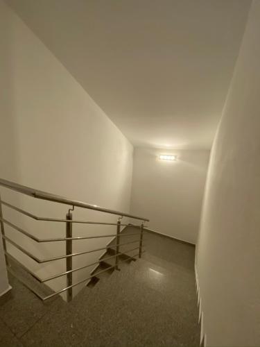 a stairway with a glass railing in a building at Apartments Grozdana in Gradac