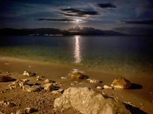 a view of the shore of a lake at night at Apartments Grozdana in Gradac