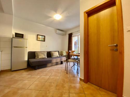 a living room with a couch and a table at Apartments Grozdana in Gradac