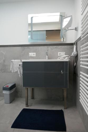 a bathroom with a sink and a mirror at Appartement Haus Schröder in Söll