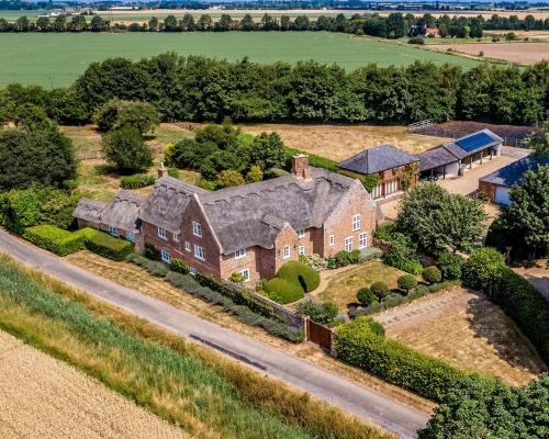 an aerial view of a house with a road at Old Hall Country Breaks in Tilney All Saints