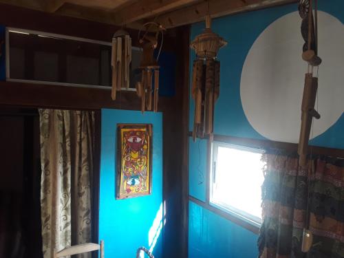 a room with blue walls and a window at El Tucán 1 in Punta Del Diablo