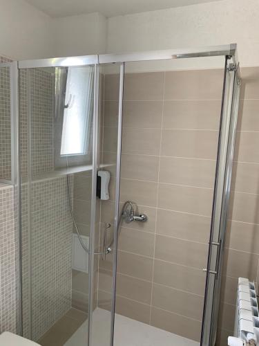 a shower with a glass door in a bathroom at Villa Detelina in Sapareva Banya