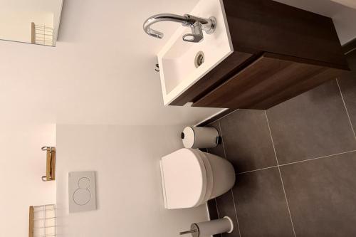a bathroom with a toilet and a sink at Appart Hotel Nivelles in Nivelles
